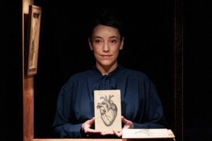 woman holding image of heart